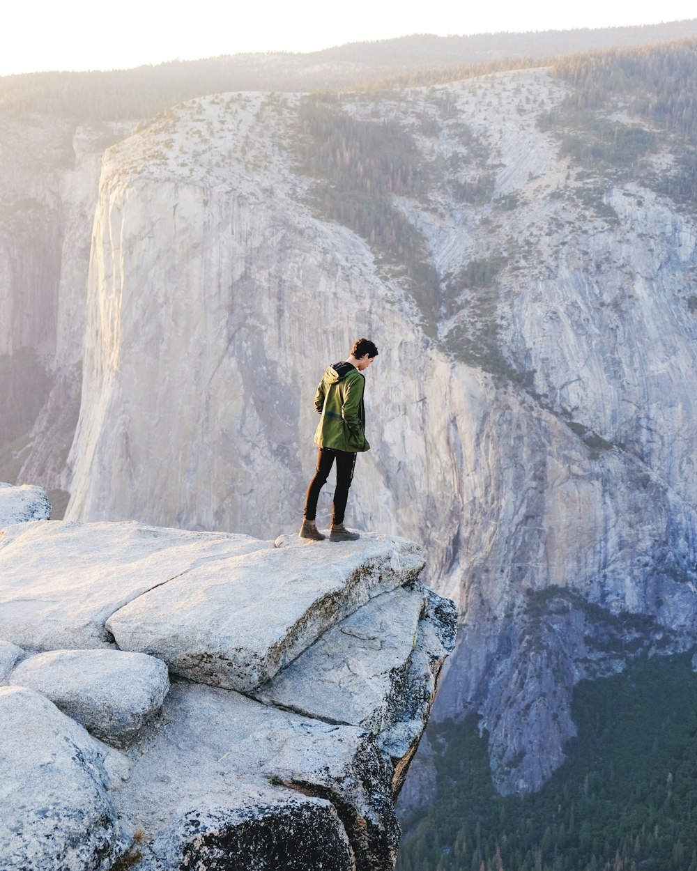 standing man looking on cliff at daytime