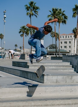 man playing skateboard on gray concrete stairs