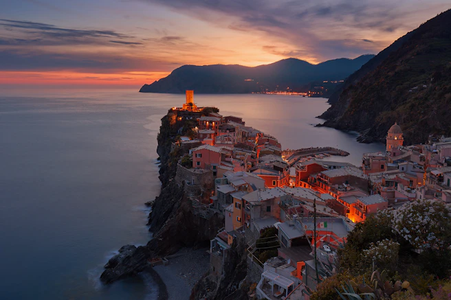 aerial view of village on mountain cliff during orange sunset