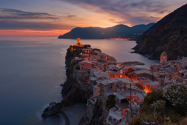 aerial view of village on mountain cliff during orange sunset