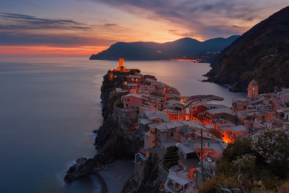 aerial view of village on mountain cliff during orange sunset