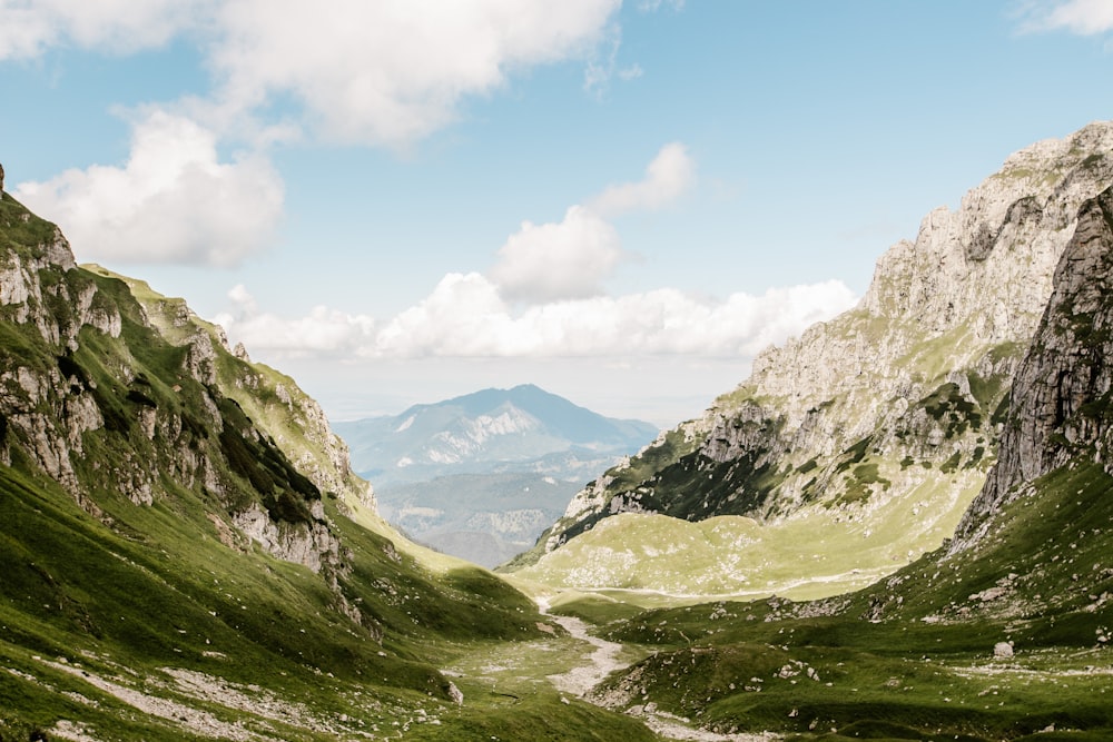 green mountains under cloudy sky