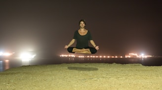 A calm person meditating with glowing zodiac symbols floating around.