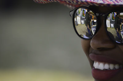 Close-up portrait of El Conejo Malo wearing signature sunglasses and a stylish hat.