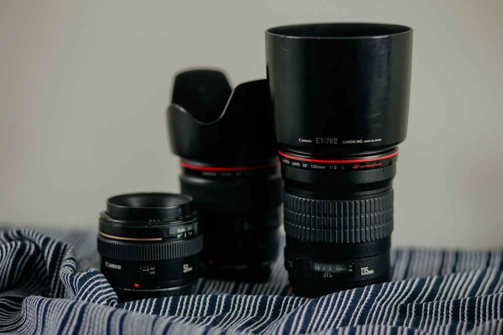 a couple of cameras sitting on top of a bed