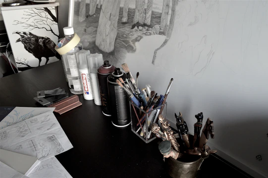 An artist’s desk scattered with sketches of mythical creatures and handwritten story notes.