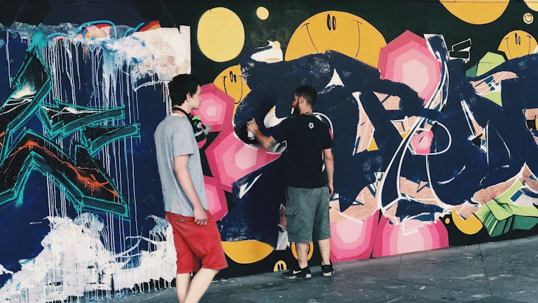 Youth engaged in a creative art project, painting vibrant murals on a community wall.