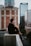 man sitting on white concrete building during daytime