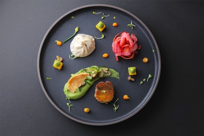 brown and white food on black ceramic plate dish teams background