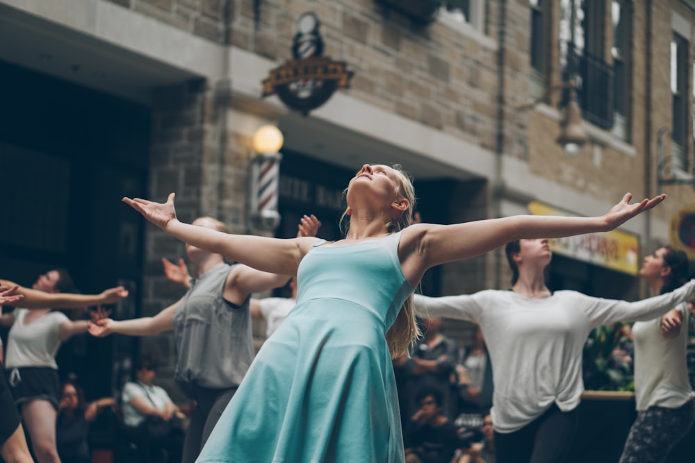 people dancing on street at daytime