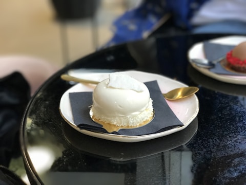 Elegant black and white photo of a plated dessert with soft lighting