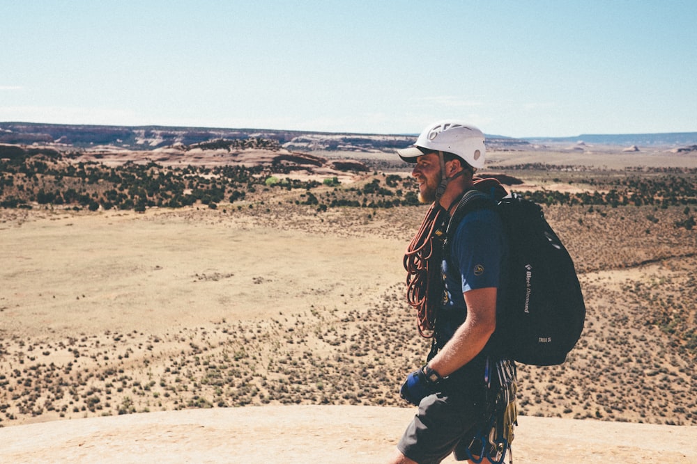 man carrying black backpack during daytime