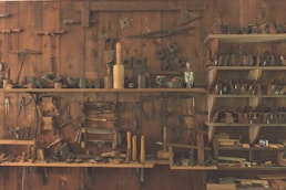 assorted hand tool lot on brown wooden shelf