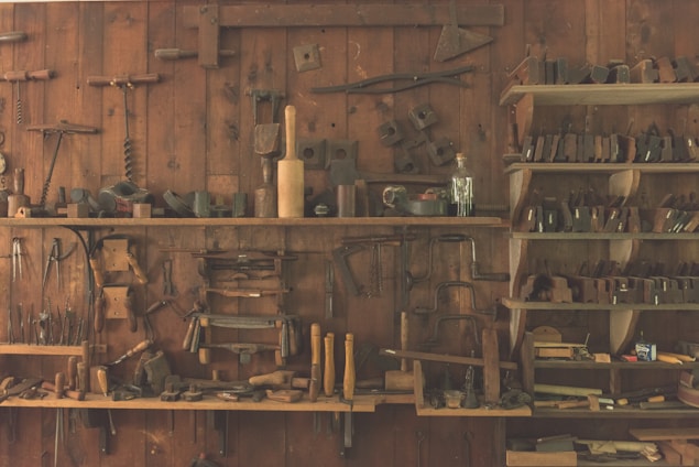 A collection of wooden materials and construction tools displayed in a well-organized workspace.