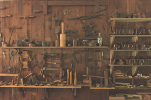 A vibrant display of assorted hand tools neatly arranged on wooden shelves inside Ramdev Traders.
