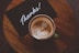 flat lay photography of coffee latte in teacup on table