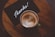 flat lay photography of coffee latte in teacup on table