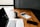 MacBook Pro, white ceramic mug,and black smartphone on table