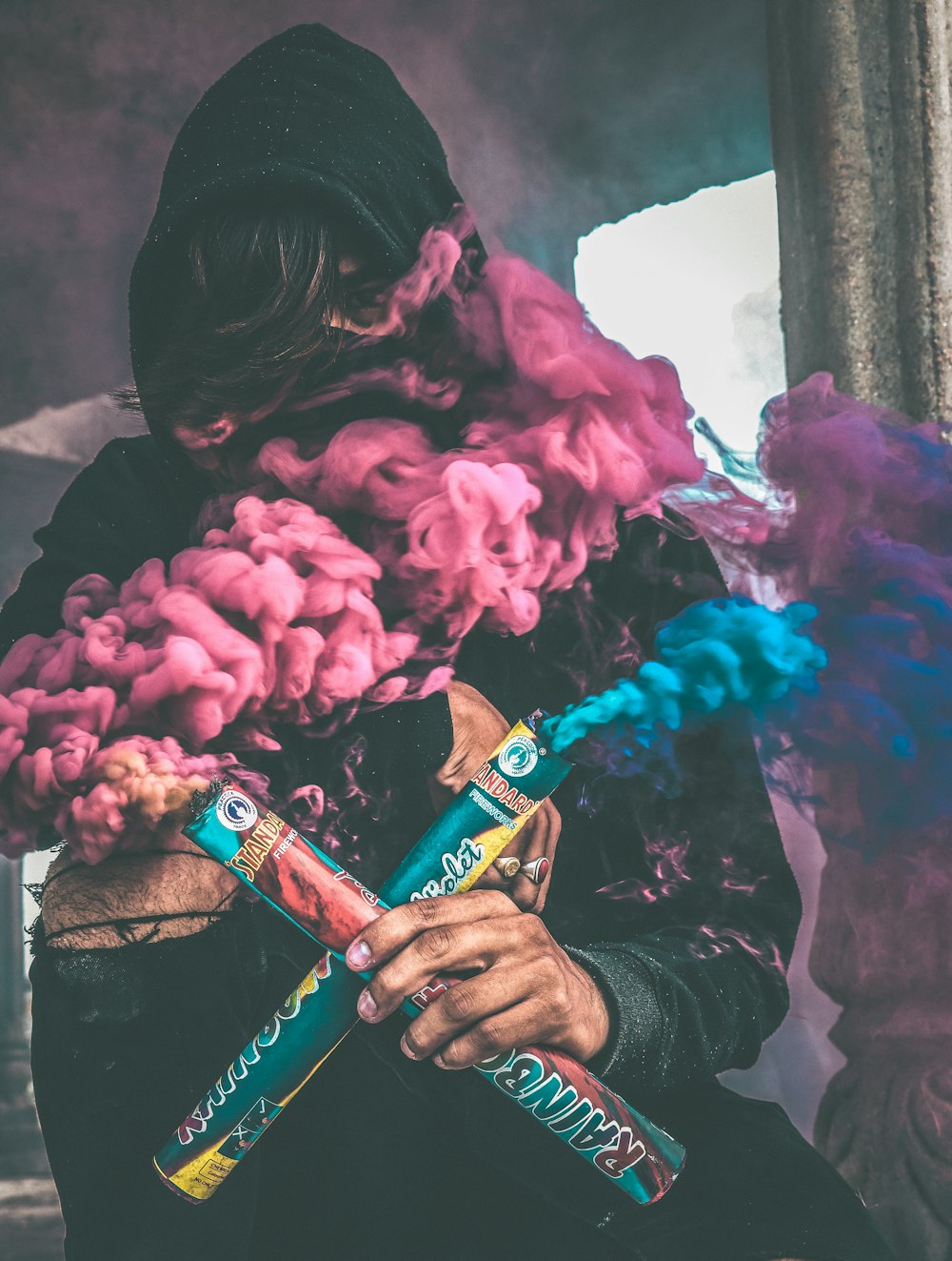 person holding colored smoke