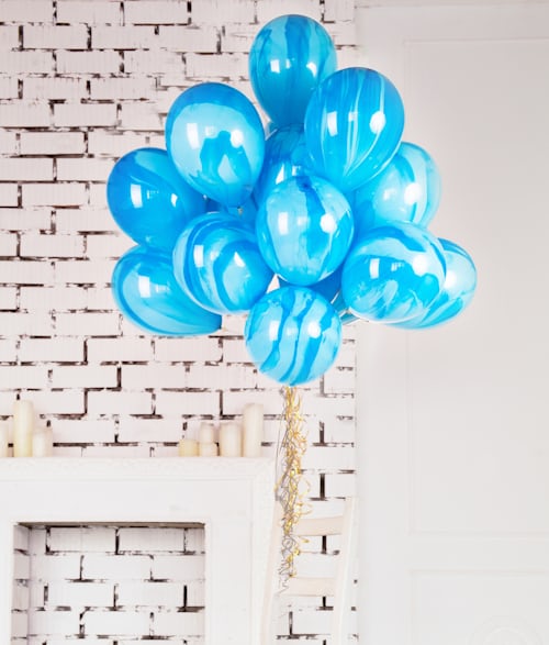 blue aesthetic balloon in front of wall