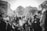 A diverse group of people engaging with their smartphones in a vibrant urban setting.