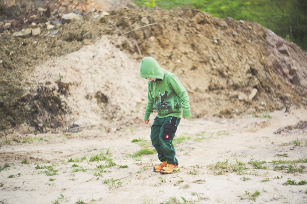 shallow focus photo of person in green hoodie