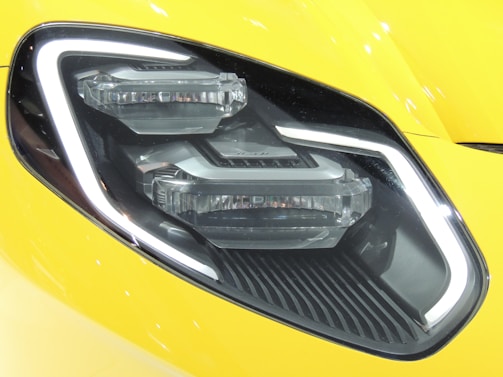 Side-by-side comparison of a yellowed headlight and a freshly renovated one on the same vehicle.