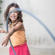 girl playing hula hoop on his arm