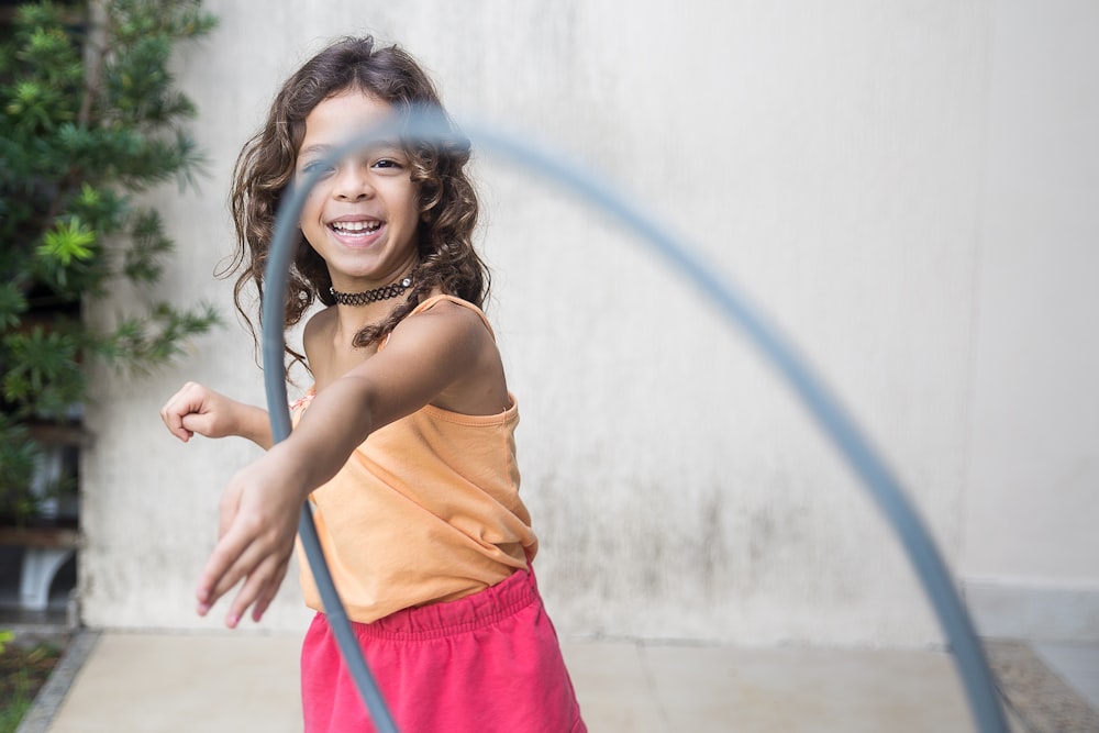 girl playing hula hoop on his arm