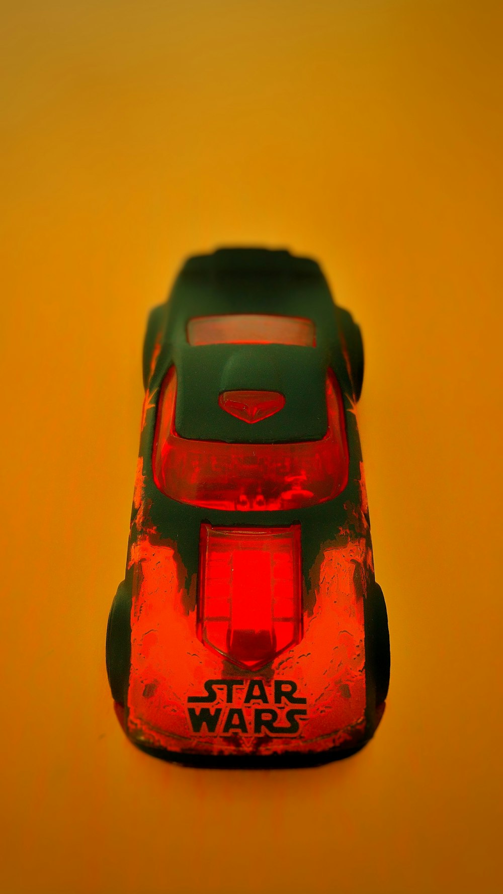 A Star Wars car on an orange surface.