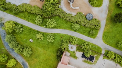 Aerial view of the memorial garden showing green lawns and shaded resting areas.