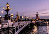 The Pont Alexandre III bridge illuminated at night in Paris, France