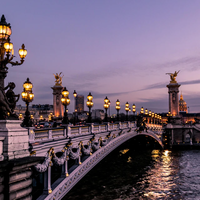 The Pont Alexandre III bridge illuminated at night over the Seine in Paris