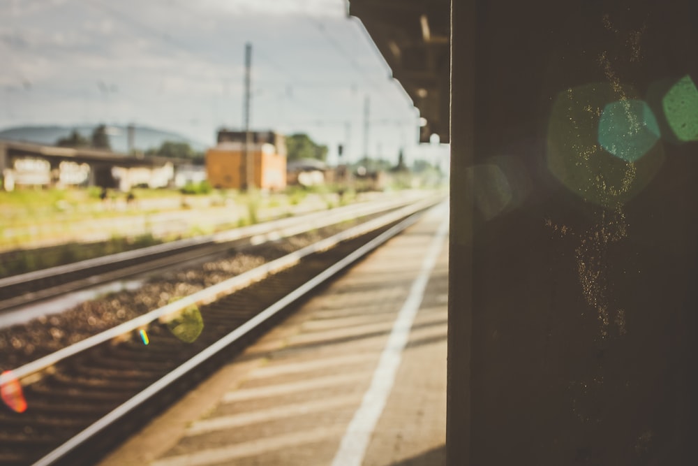 gray metal train rail during daytime