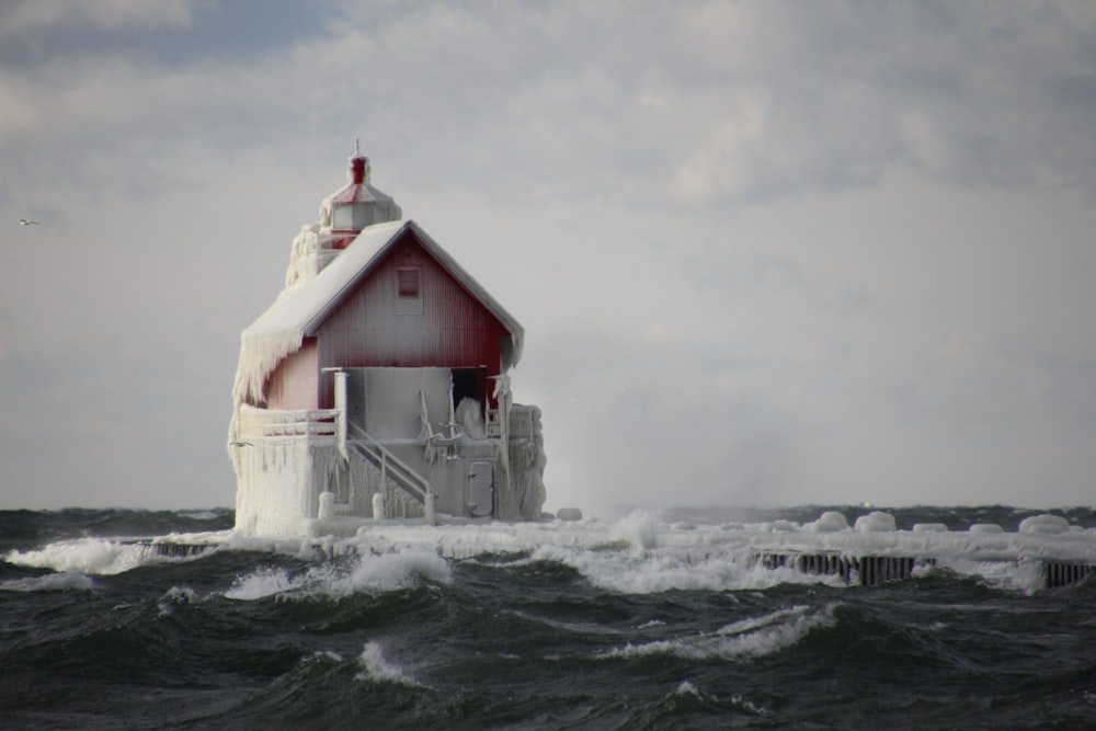 red structure covered snow in middle ocean