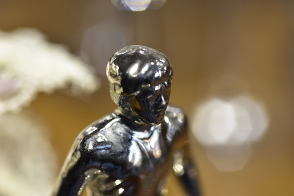 A close-up of a detailed 3D printed miniature figurine in vibrant colors on a clean white background.