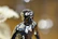 Close-up photo of a finely detailed 3D printed miniature figurine on a wooden desk.