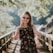 woman standing on wooden bridge