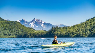 woman kayaking on lake during daytime