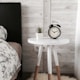 black alarm clock at 10:10 on white wooden table near table