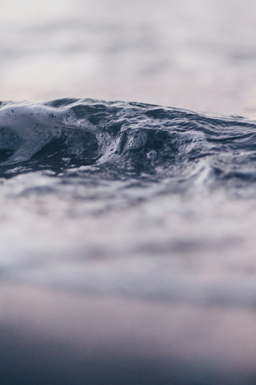 selective focus photography of water