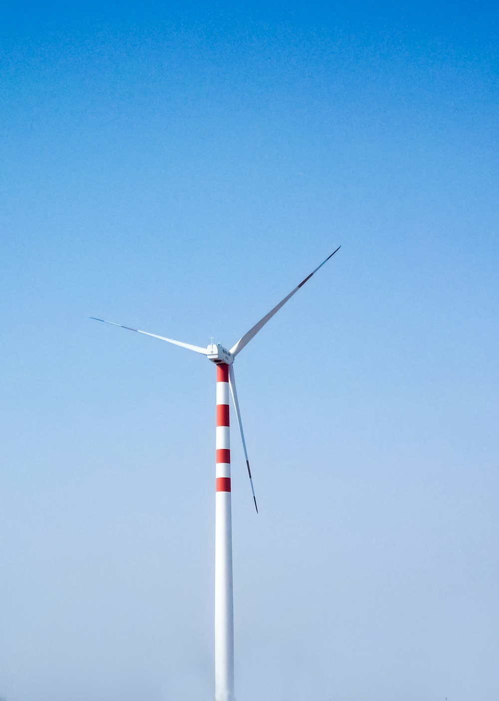 white and red windmill during daytime