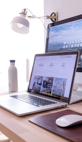 MacBook Pro on table beside white iMac and Magic Mouse