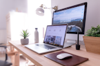 MacBook Pro on table beside white iMac and Magic Mouse