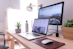 MacBook Pro on table beside white iMac and Magic Mouse