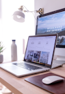 MacBook Pro on table beside white iMac and Magic Mouse