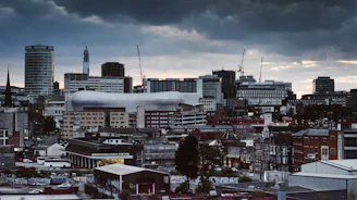 concrete building and houses under gray sky