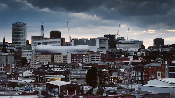 concrete building and houses under gray sky