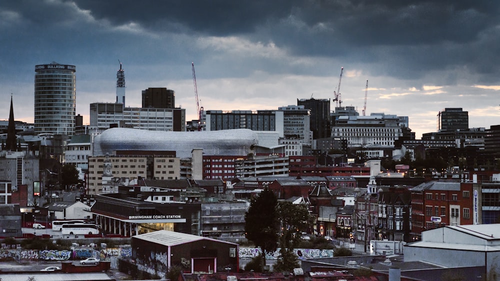 concrete building and houses under gray sky