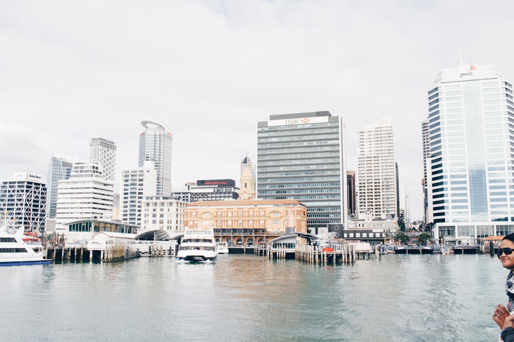 white ship on body of water in front of building